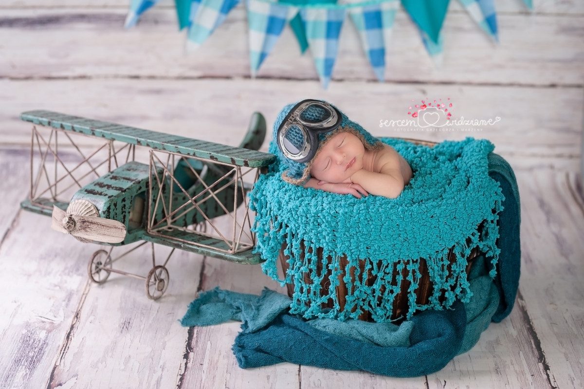 flying baby Newborn sleeping peacefully in a toy airplane, symbolizing the journey of flying with a baby.