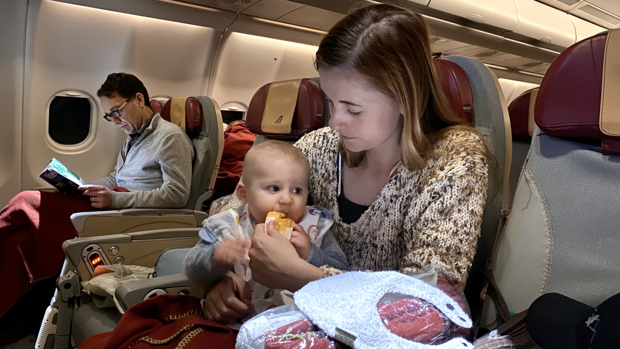 baby eating on a plane Mother with baby eating on a plane